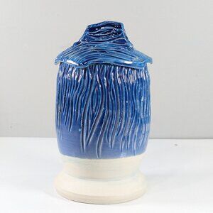Handmade carved pottery storage jar in blue and white
